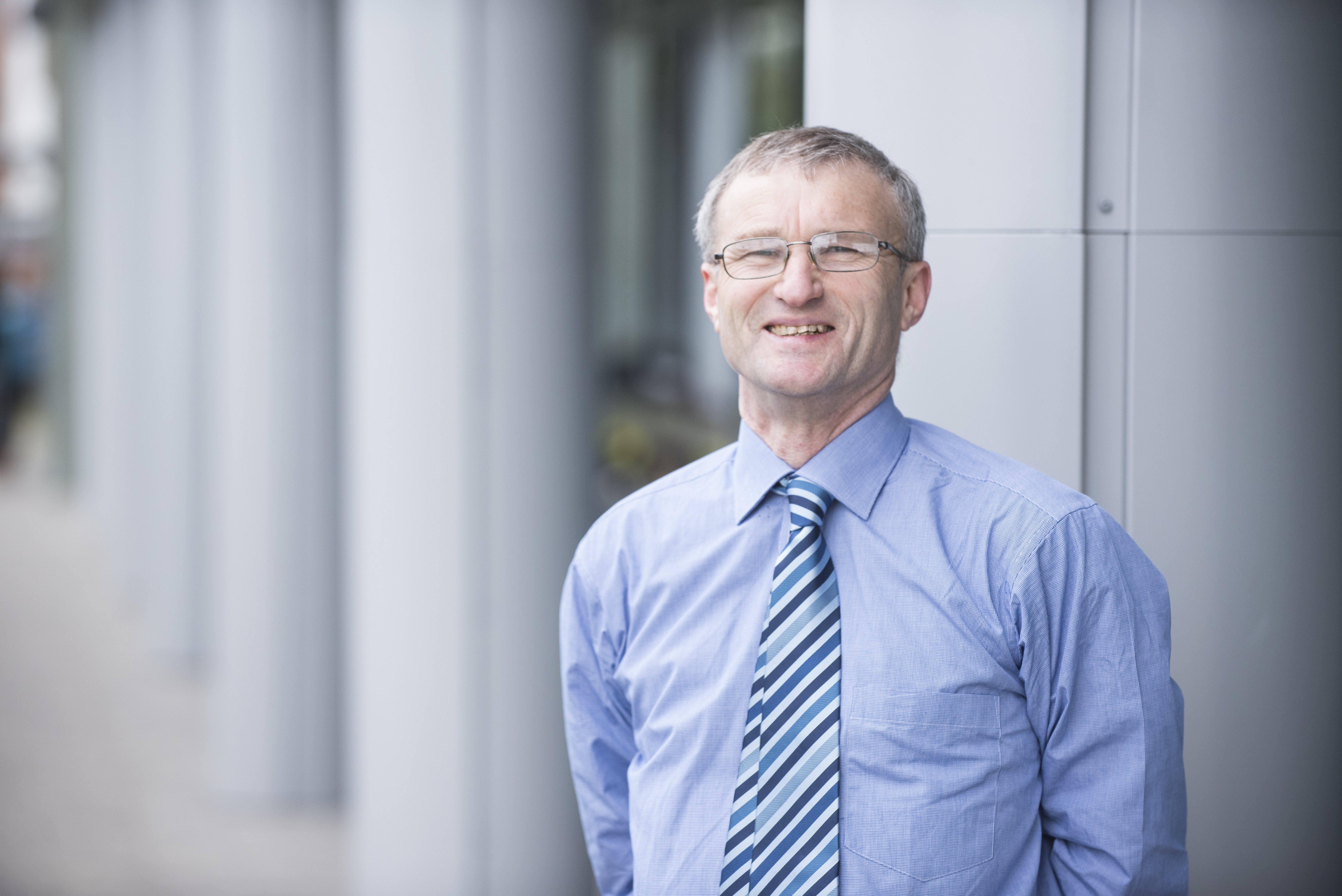 Veterinary Evidence's Editor-in-Chief, Peter Cockcroft, standing outside a building, smiling to the camera